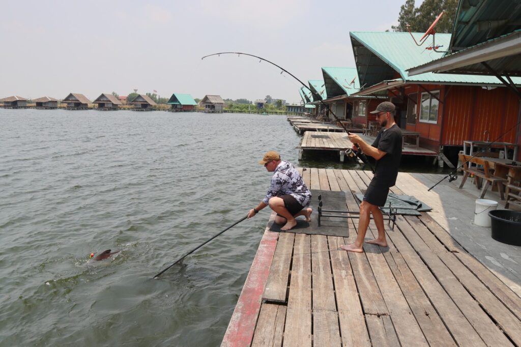 Comfortable lake bungalow with shaded deck and Thai dining, part of a top adventure things to do in Bangkok fishing experience.