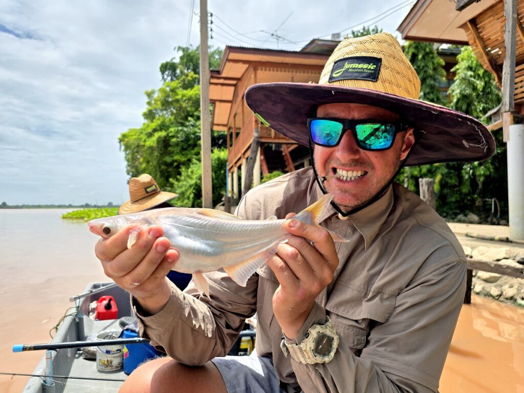 Catch the world's biggest carp species in Bangkok with Fish Thailand Mouse striped catfish caught on the Chao Phraya River in Bangkok