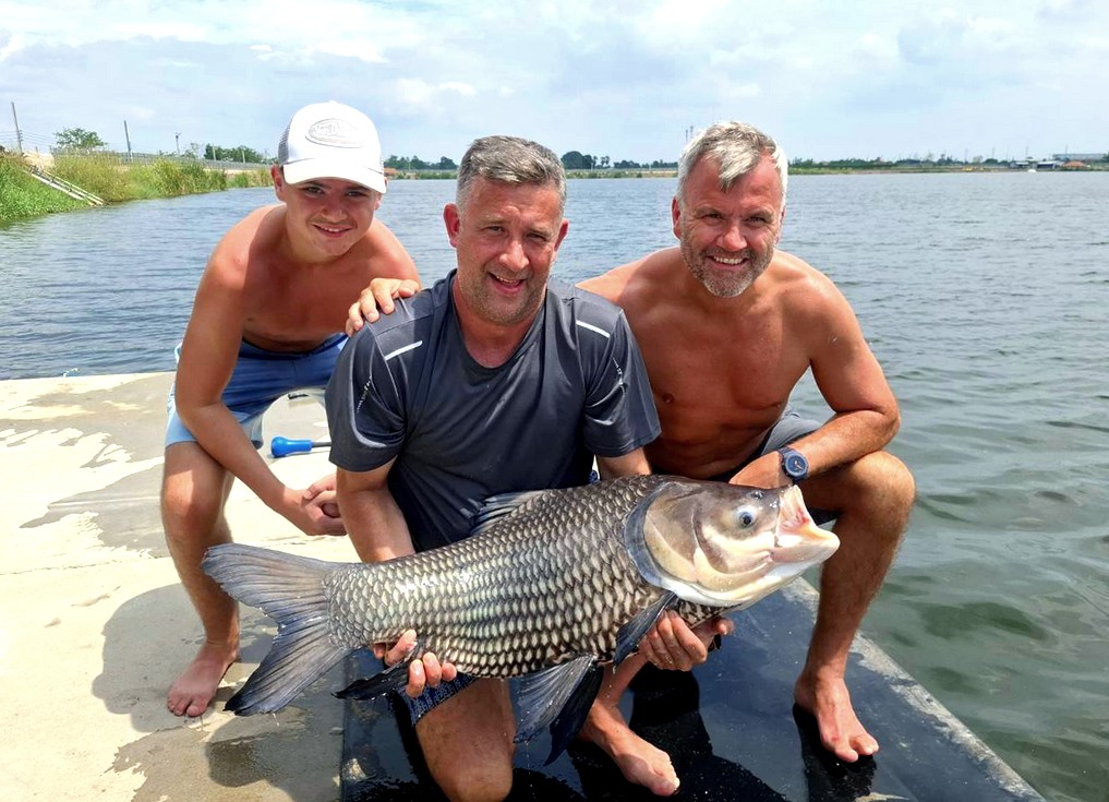 family holding a siamese carp they caught at bang len fishing lake